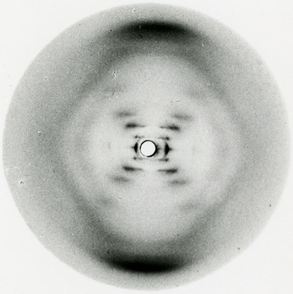 Fuzzy black-and-white image showing an elongated hexagon with an X-shape radiating out from its center.